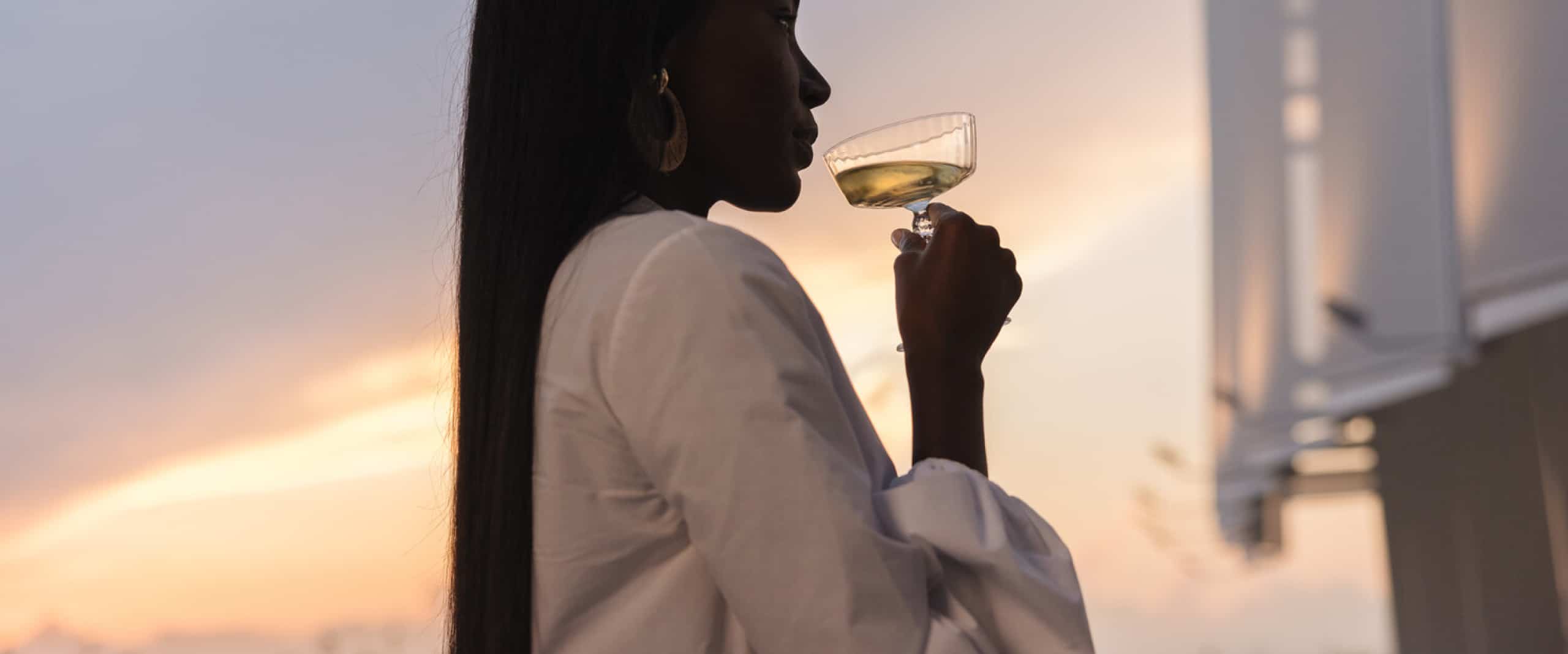 St. Regis Residences hero with woman drinking wine.